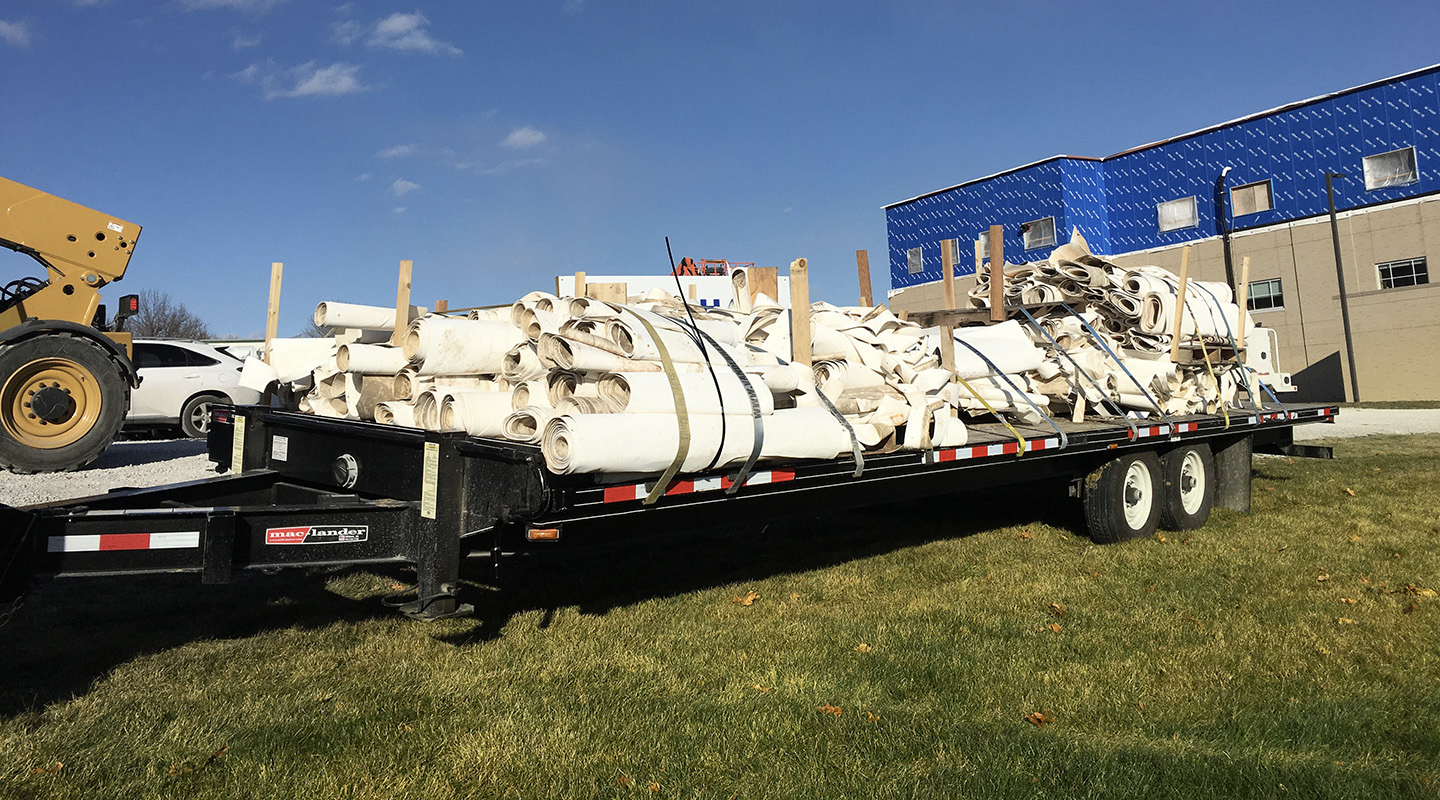 Trailer load of used Duro-Last Roofing material being transported for recycling.